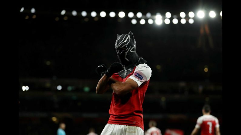 Pierre-Emerick Aubameyang of Arsenal celebrates with a Black Panther mask as he scores for 3-0 in the 72nd minute of a match at Emirates Stadium in London on Thursday, March 14.