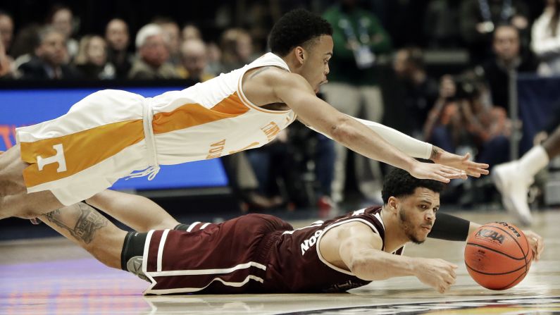 Tennessee guard Lamonte Turner, top, and Mississippi State guard Quinndary Weatherspoon dive for a loose ball in the second half of an NCAA college basketball game at the Southeastern Conference tournament in Nashville on Friday, March 15.