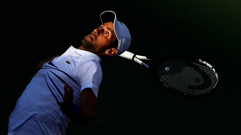 Novak Djokovic of Serbia serves while playing with Fabio Fognini of Italy against Lukasz Kubot of Poland and Marcelo Melo of Brazil during their men's doubles semifinal match on day 12 of the BNP Paribas Open in Indian Wells, California, on Thursday, March 15.