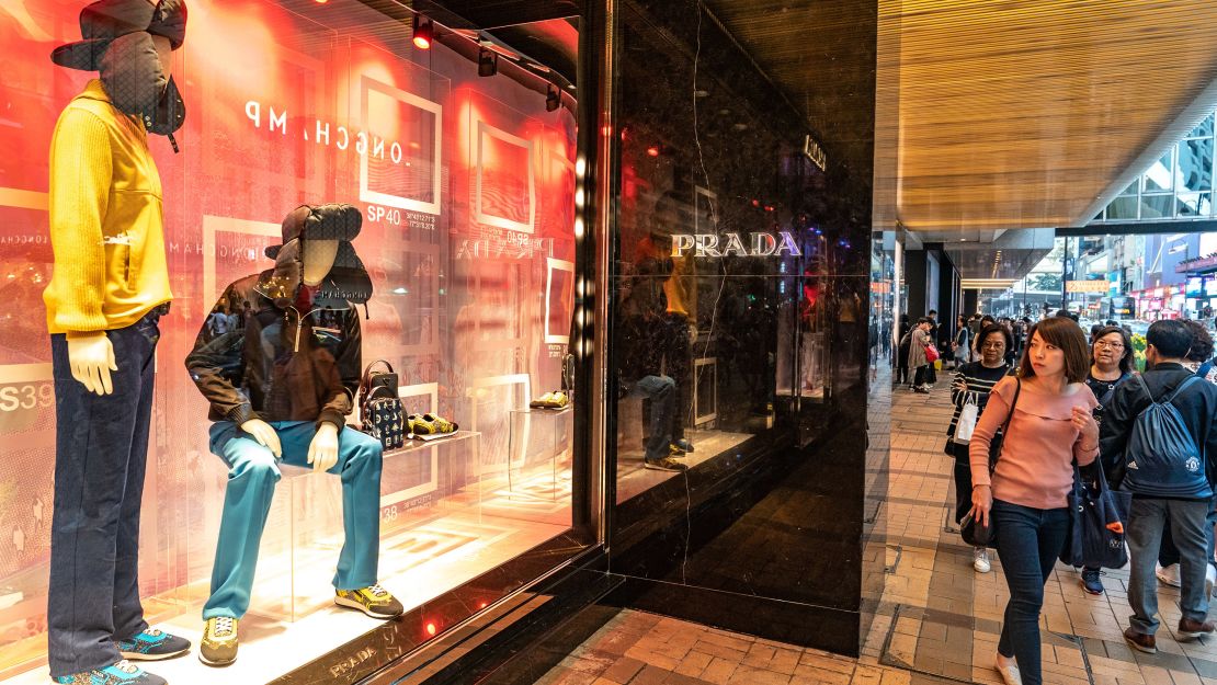 FILE--Pedestrians walk past the fashion boutique of Louis Vuitton