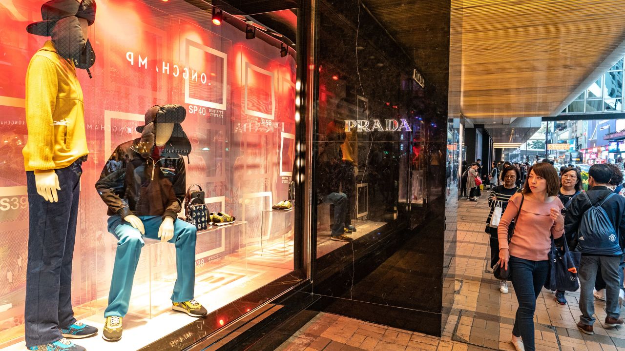 Pedestrians walking past a Prada store in Hong Kong. The company posted disappointing earnings on Friday, sending its stock down as much as 10%.