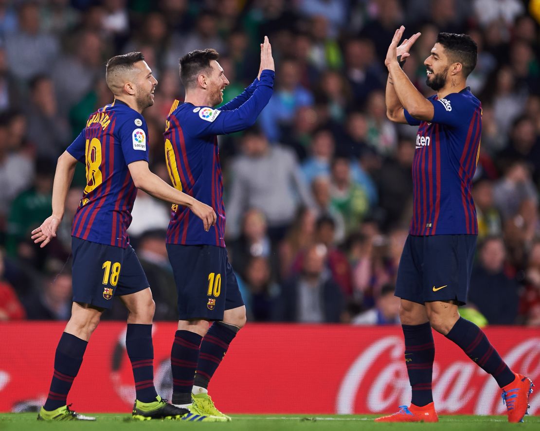 Messi celebrates with Suarez and Jordi Alba after scoring Barca's second goal of the night