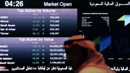 A Saudi man looks at stocks at the Tadawul Saudi Stock Exchange, in Riyadh, Saudi Arabia, Monday, June 15, 2015. Saudi Arabia's stock market, valued at $585 billion, opened up to direct foreign investment for the first time Monday, as the kingdom seeks an economic boost amid low global oil prices. (AP Photo/Hasan Jamali)