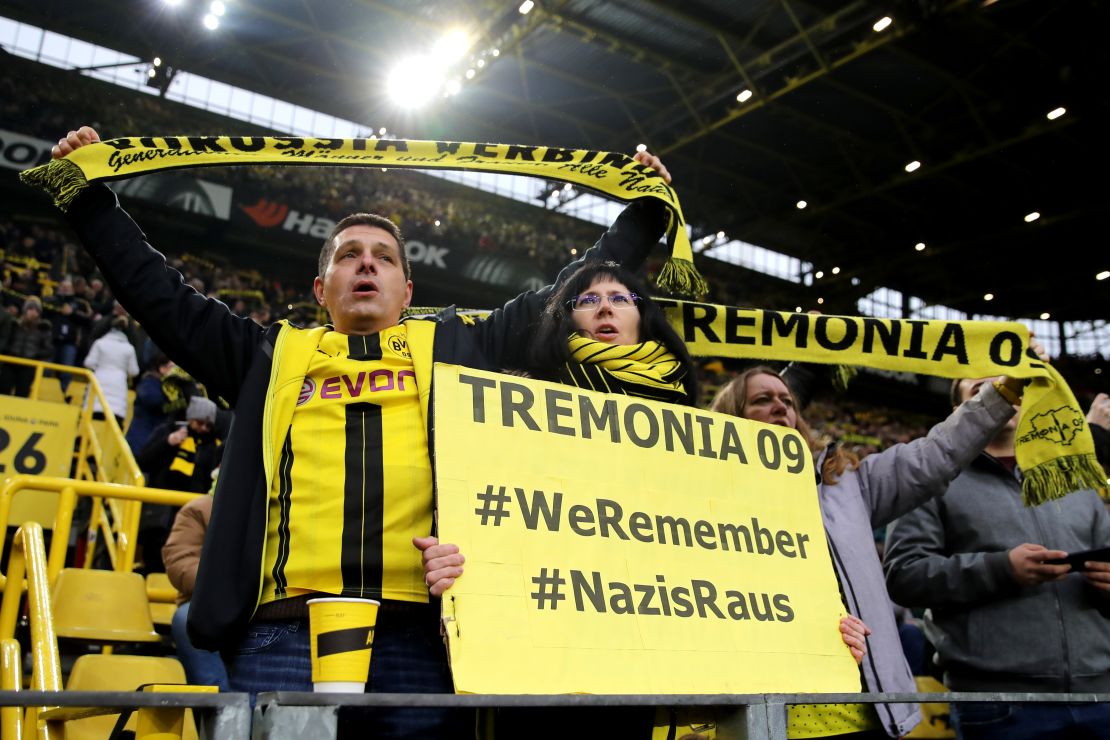 Borussia Dortmund fans display signs in tribute to victims of the Holocaust.