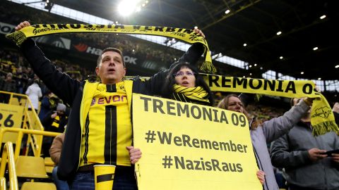 Borussia Dortmund fans display signs in tribute to victims of the Holocaust.