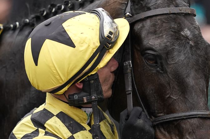 Jockey Paul Townend gives Al Boum Photo a kiss after they win the prestigious Cheltenham Gold Cup, the showpiece of jump racing's blue-riband Cheltenham Festival.
