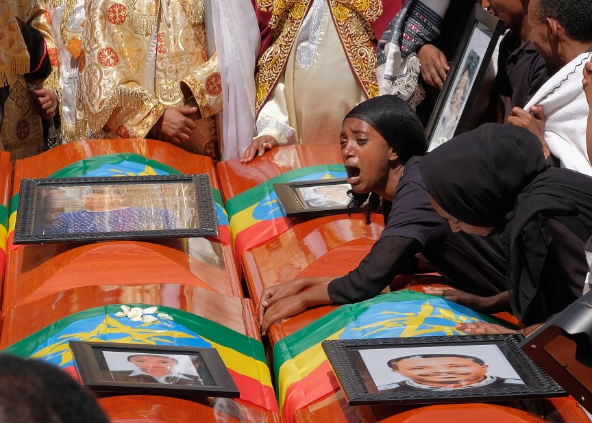 A woman lays on the coffin of her loved one during a memorial service on March 17 for the Ethiopian passengers and crew who died in the Ethiopian Airlines crash. All 157 people aboard the Boeing 737 Max 8 died when the flight went down six minutes after taking off from Bole Airport.