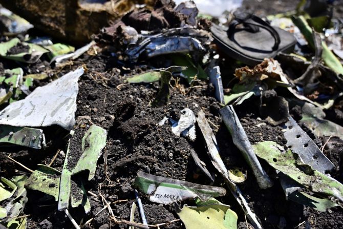 Debris including a charred part of an onboard safety instruction card is seen at the crash site of an Ethiopian Airlines flight on March 16, at Hama Quntushele village near Bishoftu in the Oromia region. 