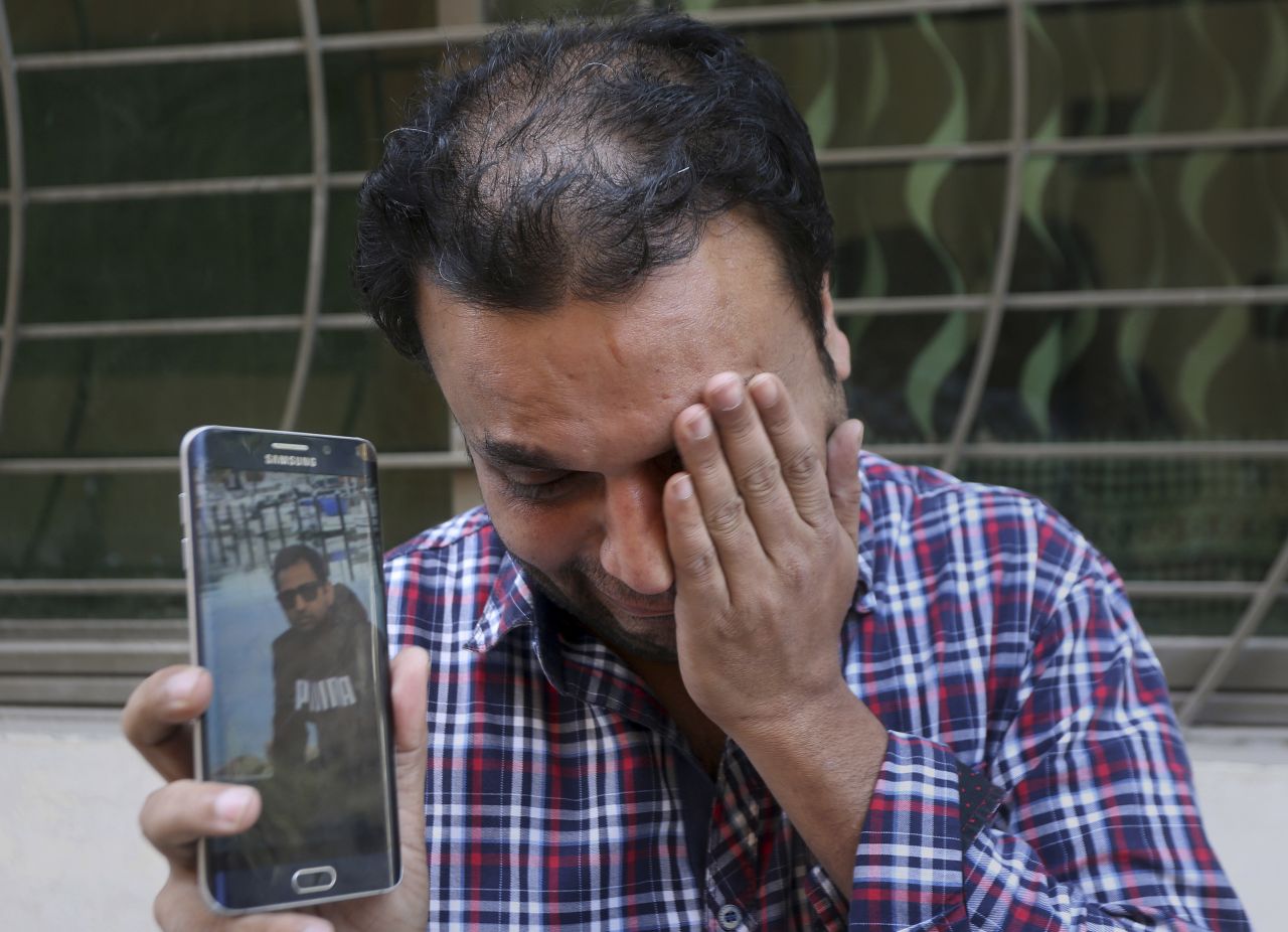 A relative weeps while showing the picture of Sohail Shahid, a Pakistani citizen who was killed in the Christchurch mosque shootings, on his cell phone outside his home in Lahore, Pakistan, Sunday, March 17. Pakistan's foreign ministry spokesman says three more Pakistanis have been identified among the dead, increasing the number of Pakistanis to nine killed in the mass shootings at two mosques in the New Zealand city of Christchurch.