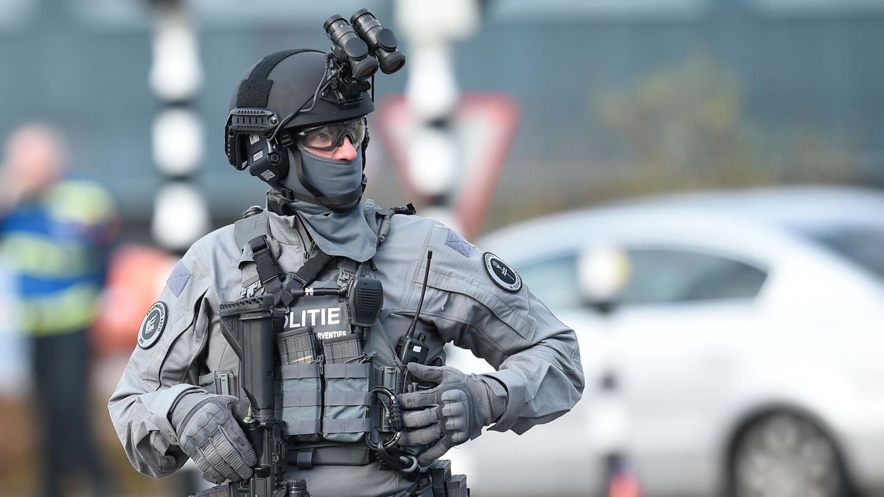 A member of Dutch special police forces patrols the area near the shooting.