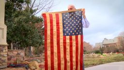 Richard Oulton holds the American flag that flew over his bunker during the Vietnam War.