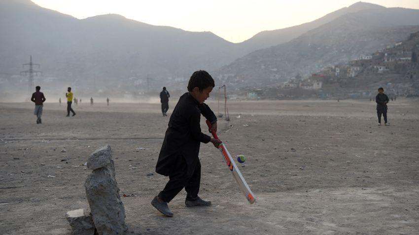 Afghan boys play cricket at an esplanade at Shuhada Lake in Kabul on December 23, 2018