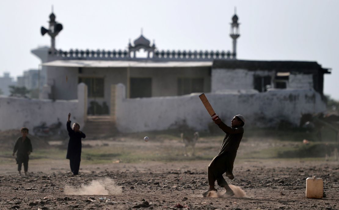 Afghan children play cricket at a refugee camp in Islamabad in October 2018.