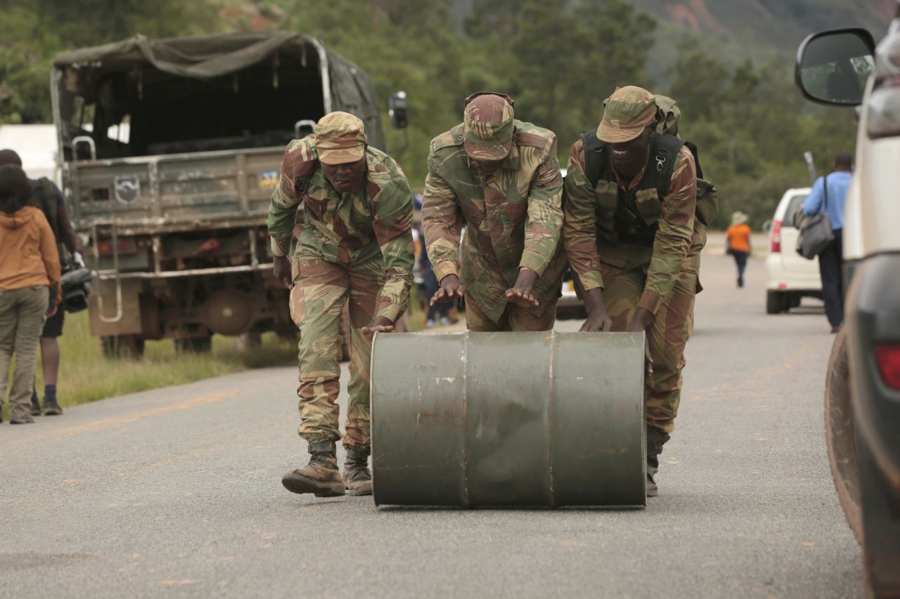 Soldiers push a drum of jet fuel used for rescue operations in Chimanimani on March 19.