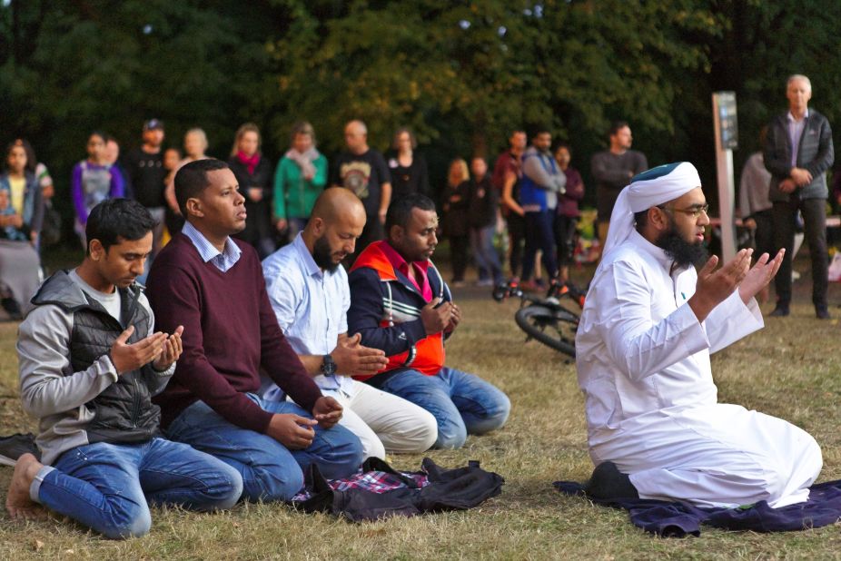 Mufti Zeeyad Ravat, right, a Muslim leader from Melbourne, leads a prayer at the Deans Avenue memorial, near the Al Noor mosque in Christchurch, New Zealand, on Tuesday, March 19.