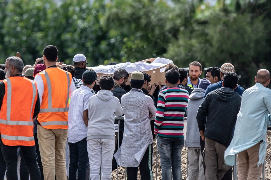 Mourners carry the coffin of a shooting victim during a funeral at the Memorial Park Cemetery in Christchurch on Wednesday, March 20. Hundreds of mourners gathered for the first funerals of those killed as New Zealanders braced for days of emotional farewells.