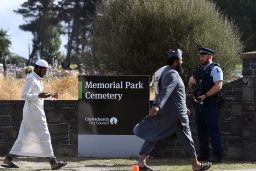 An armed policeman keeps watch as mourners arrive to attend funerals for victims killed in the mosque massacre in Christchurch, New Zealand.