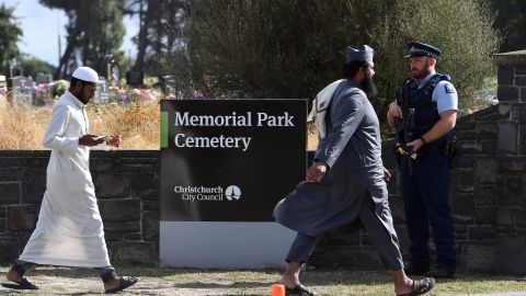 An armed policeman keeps watch as mourners arrive to attend funerals for victims killed in the mosque massacre in Christchurch, New Zealand.
