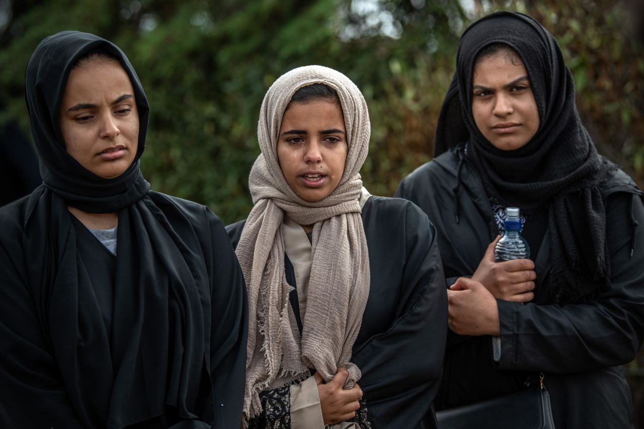 Women mourn at Memorial Park Cemetery on March 20 after attending the funerals of two victims of the Christchurch terrorist attack.