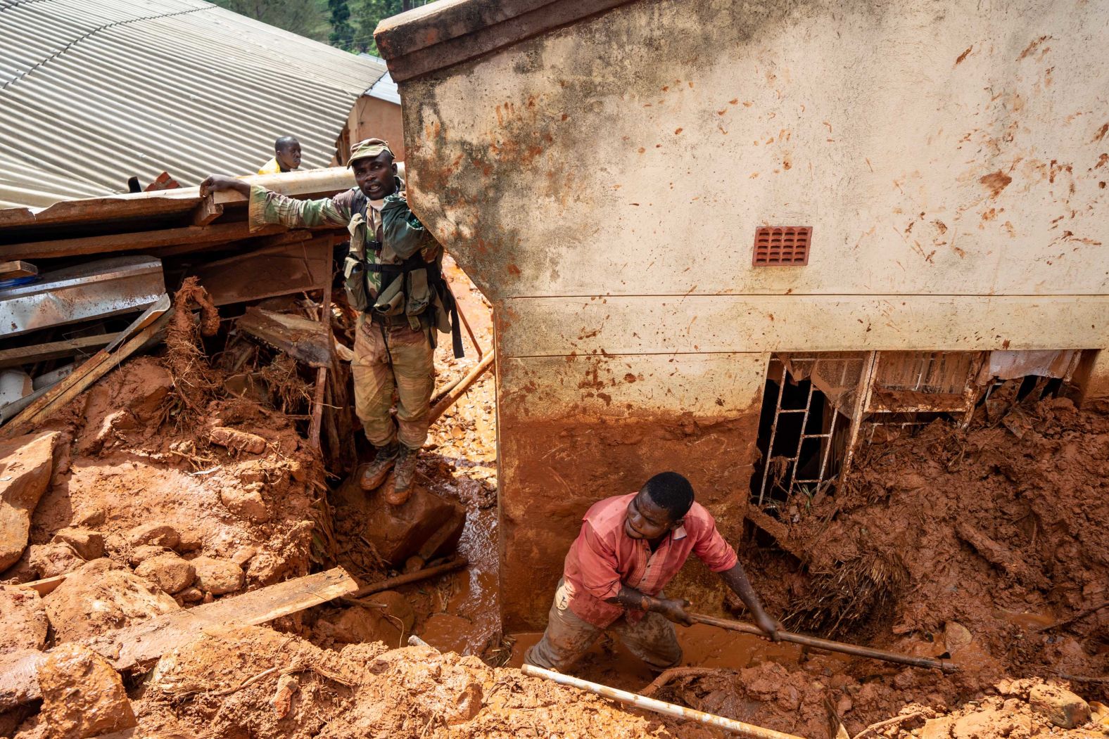 Soldiers help residents retrieve their lost belongings on Tuesday, March 19, in Chimanimani, Zimbabwe.