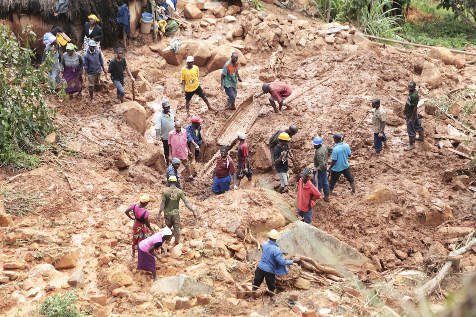 A family digs on March 19 for their son who got buried in the mud when Cyclone Idai struck in Chimaniman.