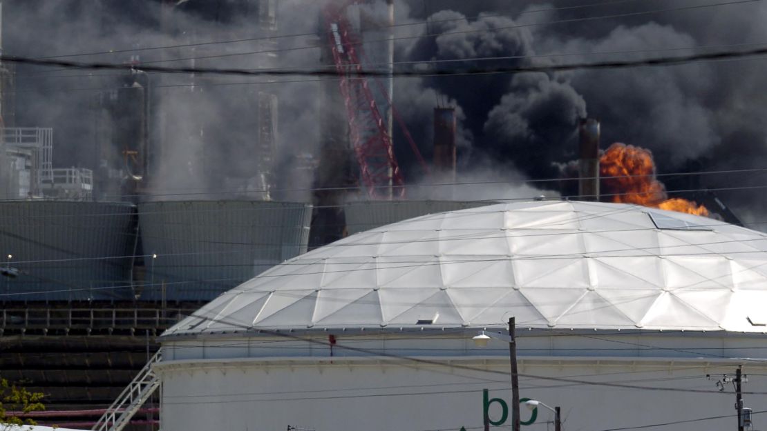 Flames erupt from the BP Amoco PLC oil refinery plant in Texas City, Texas after an explosion.