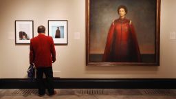 LONDON, ENGLAND - MAY 16:  A man views images of Her Majesty Queen Elizabeth II inculding one by artist Pietro Annigoni entitled 'Queen Elizabeth II' (R) in the National Portrait Gallery's exhibition 'The Queen: Art & Image' on May 16, 2012 in London, England. The exhibition, which opens to the public on May 17, 2012 and runs until October 21, 2012, features a wide-ranging display of images of The Queen from throughout her 60 year reign.  (Photo by Oli Scarff/Getty Images)