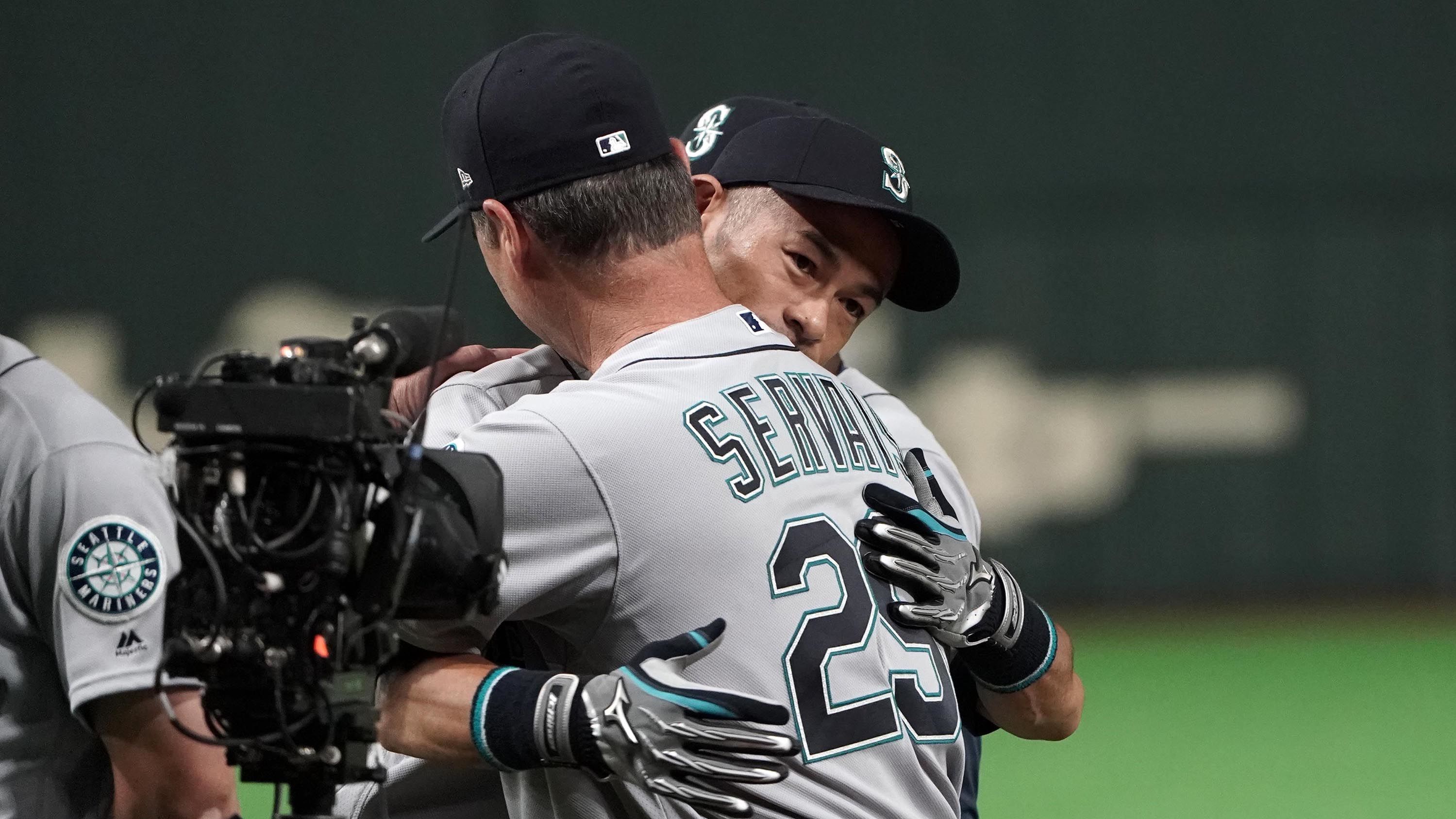 Ichiro hugs Mariners manager Scott Servais as he is introduced prior to the game.