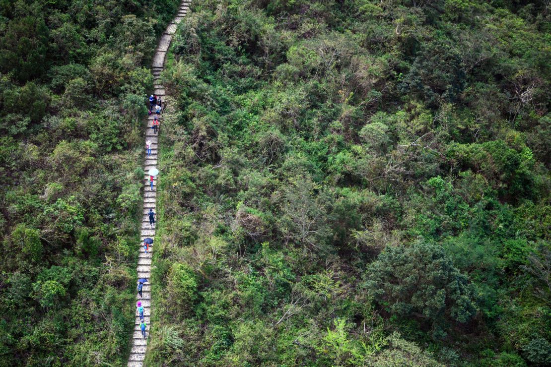 In this photo taken on October 7, 2018, hikers walk along the Ngong Ping Trail on Lantau island in Hong Kong. 