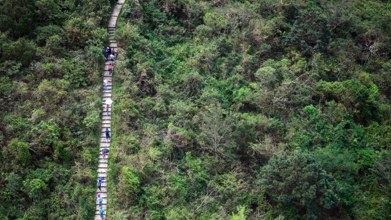 In this photo taken on October 7, 2018, hikers walk along the Ngong Ping Trail on Lantau island in Hong Kong. 