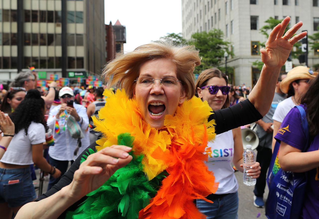 Warren runs down Boston's Clarendon Street waving to crowds during the annual Boston Pride Parade in June 2018.