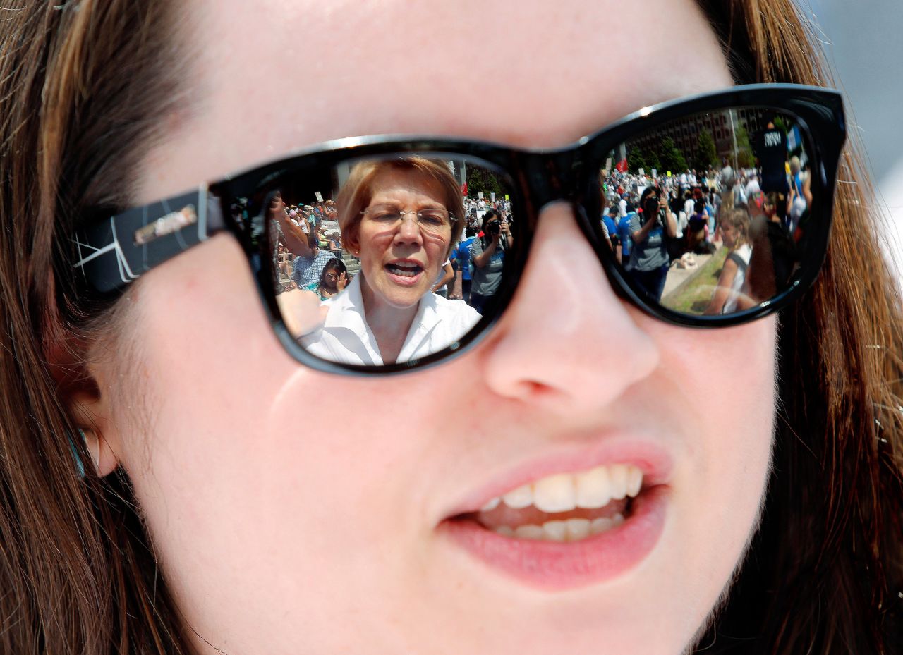 Warren is seen in the sunglasses of Arian Rustemi during a rally in Boston in June 2018. Warren was calling for the swift reunification of children and parents who had been separated at the US-Mexico border.