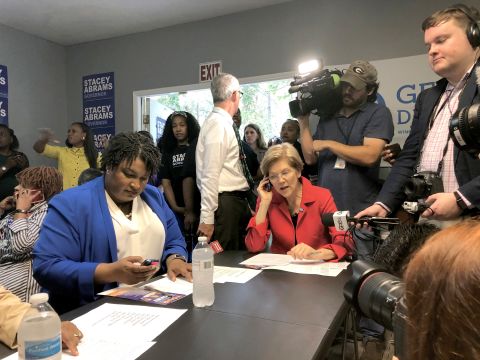 Warren helps Georgia gubernatorial candidate Stacey Abrams make calls to voters in October 2018.