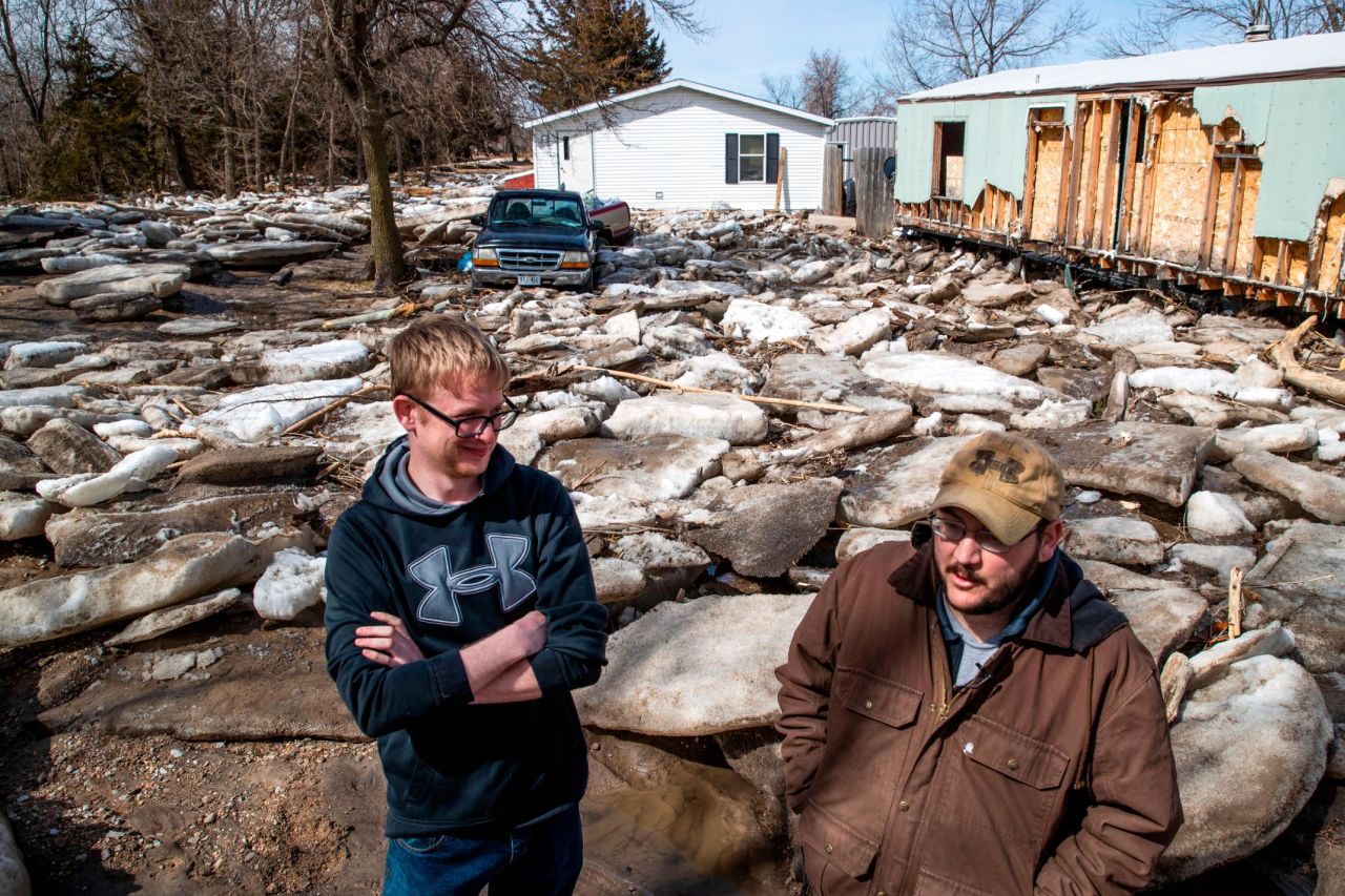Shawn Shonerd and Andrew Bauer stand in the Bellwood Lakes neighborhood on Monday, March 18, in Bellwood, Nebraska. Much of the area was heavily affected by flooding along the Platte River.