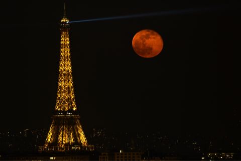 A super moon rises in the sky next to Eiffel Tower, as seen from Suresnes in Paris, France on March 20.