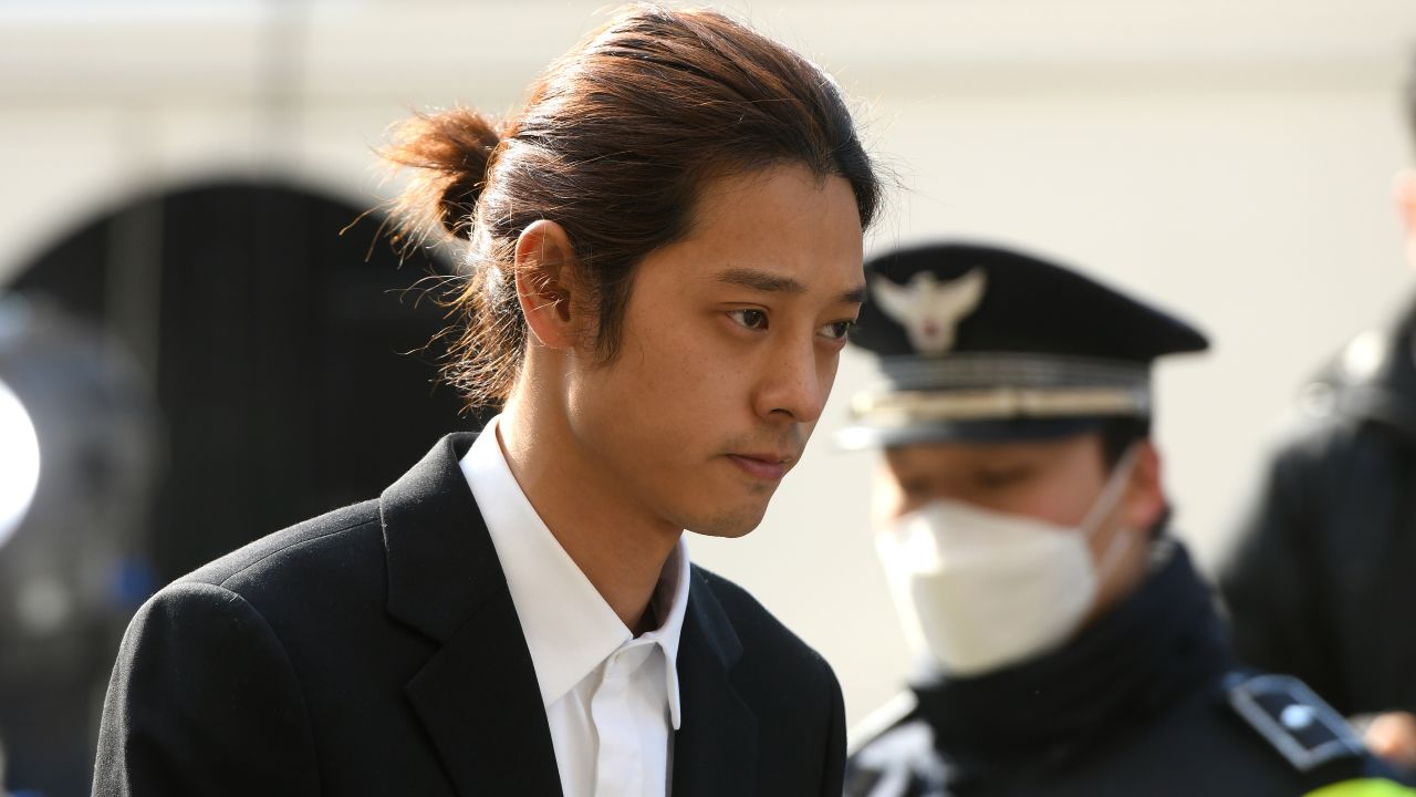 K-pop star Jung Joon-young (C) arrives for questioning at the Seoul Metropolitan Police Agency in Seoul on March 14, 2019. - A burgeoning K-pop sex scandal claimed a second scalp as a singer who rose to fame after coming second in one of South Korea's top talent shows admitted secretly filming himself having sex and sharing the footage. Jung Joon-young, 30, announced his immediate retirement from showbusiness amid allegations he shot and shared sexual imagery without his partners' consent. (Photo by JUNG Yeon-Je / AFP)        (Photo credit should read JUNG YEON-JE/AFP/Getty Images)