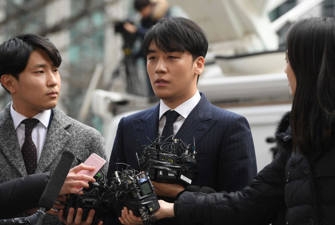 Seungri (center), a member of the K-Pop boy group BIGBANG, speaks to the media as he arrives for questioning over criminal allegations at the Seoul Metropolitan Police Agency in Seoul on March 14, 2019.