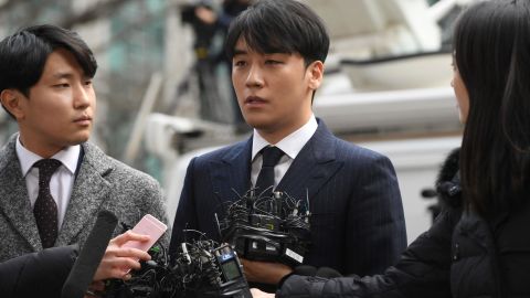 Seungri (center), a member of the K-Pop boy group BIGBANG, speaks to the media as he arrives for questioning over criminal allegations at the Seoul Metropolitan Police Agency in Seoul on March 14, 2019.
