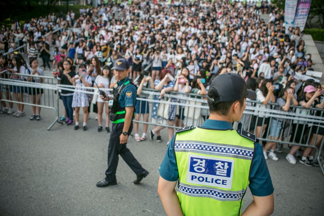 Fans wait to see K-Pop stars outside a concert in Suwon, South Korea, in 2016. 