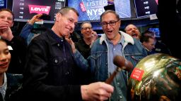 Levi Strauss CEO Chip Bergh, left, is joined by CFO Harmit Singh as he rings a ceremonial bell when his company's IPO begins trading on the floor of the New York Stock Exchange, Thursday, March 21, 2019. Levi Strauss & Co., which gave America its first pair of blue jeans, is going public for the second time. The 166-year-old company, which owns the Dockers and Denizen brands, previously went public in 1971, but the namesake founder's descendants took it private again in 1985. (AP Photo/Richard Drew)
