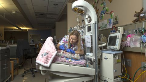 Lewis cares for a baby at McLane Children's hospital.
