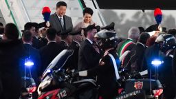 China's President Xi Jinping (Rear L) and his wife Peng Liyuan get down their plane after landing at Rome's Fiumicino airport for a two-day visit in Italy, on March 21, 2019 in Fiumicino. (Photo by Tiziana FABI / AFP)        (Photo credit should read TIZIANA FABI/AFP/Getty Images)
