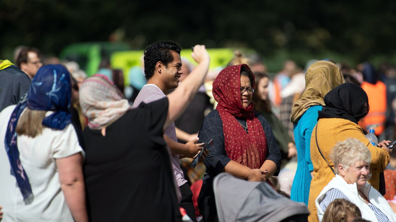 Female members of the public with head scarfs gather for the call to prayer and the moments silence at Hagley Park.