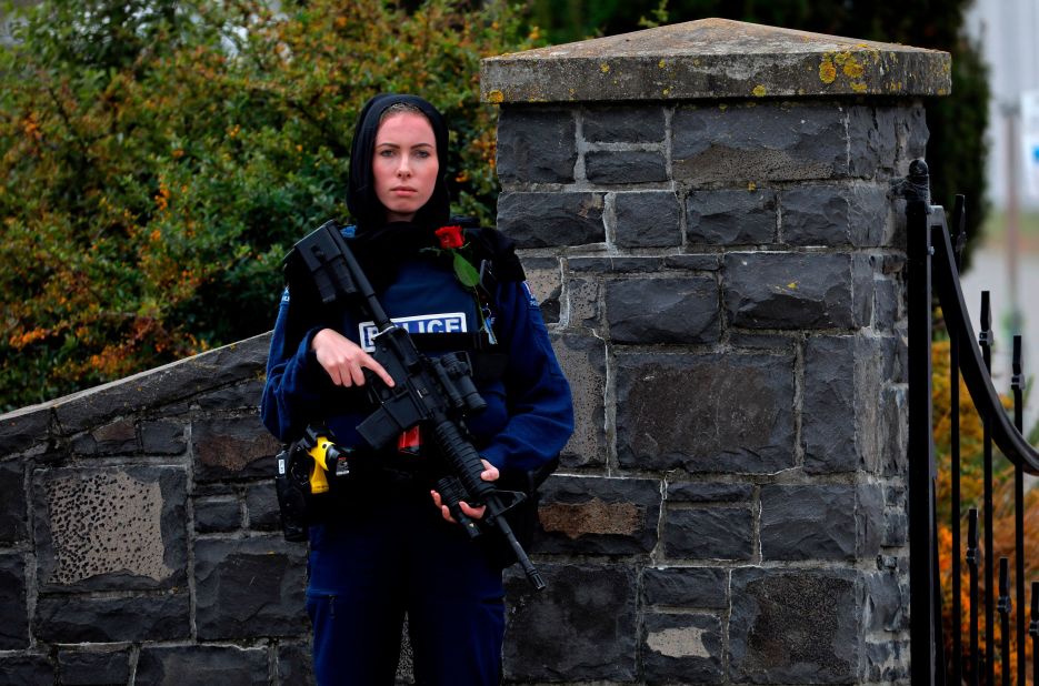 A police officer stands guard at the burial service for a victim of the mosque shootings in Christchurch, New Zealand. 