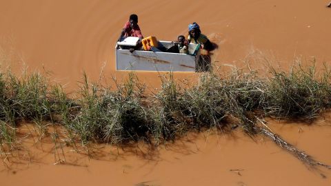 A child is transported via a refrigerator in flooding caused by Cyclone Idai in Buzi, Mozambique, on Thursday, March 21.