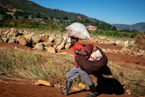 A man carrying his belongings arrives at a school in Chimanimani, Zimbabwe, where the displaced are taking shelter, on March 21.