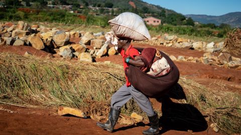 A man carrying his belongings arrives at a school in Chimanimani, Zimbabwe, where the displaced are taking shelter, on March 21.