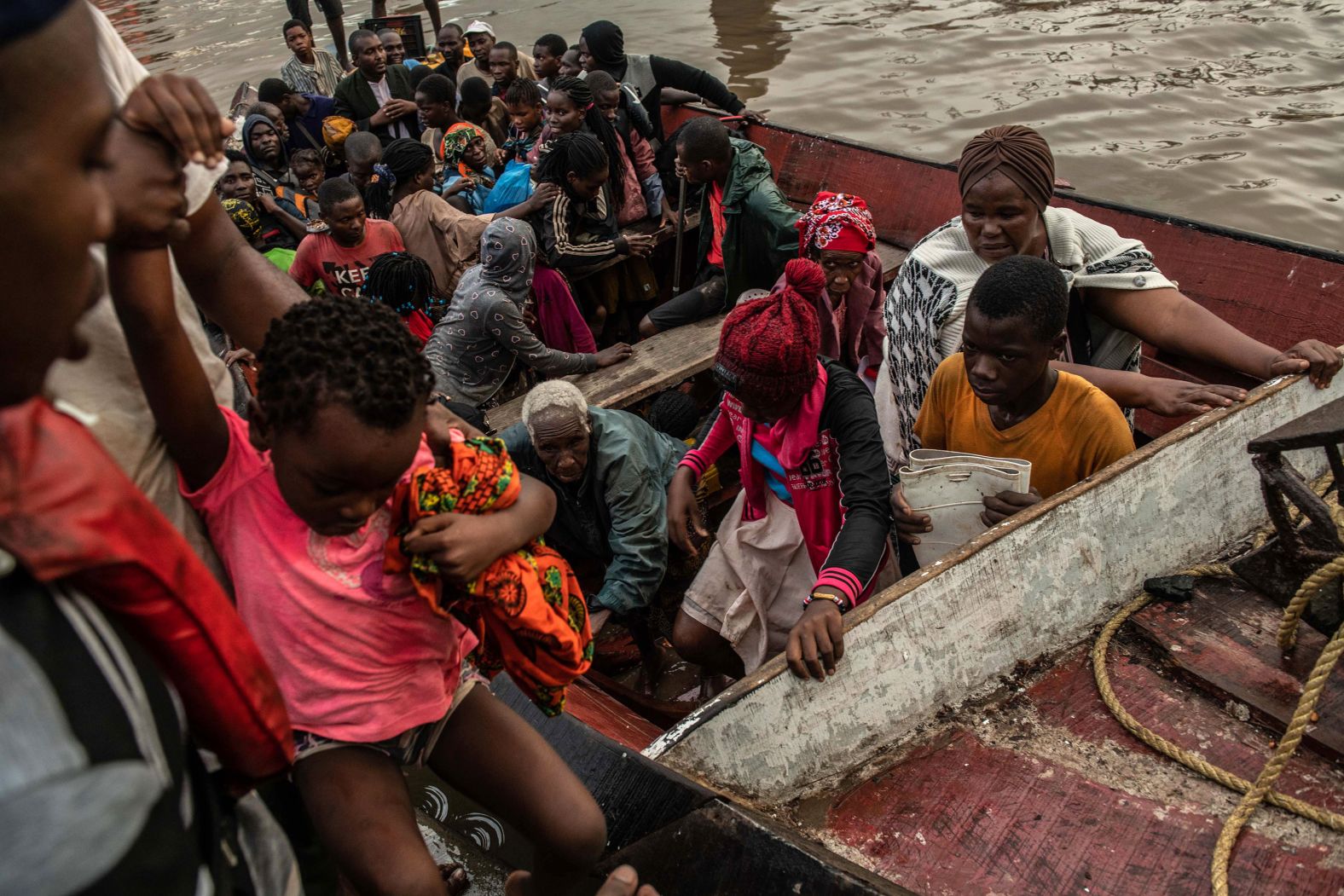 People unload from a boat in Beira, Mozambique, on Friday, March 22, after being rescued. Thousands remain stranded after Cyclone Idai hit.