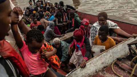People unload from a boat in Beira, Mozambique, on Friday, March 22, after being rescued. Thousands remain stranded after Cyclone Idai hit.