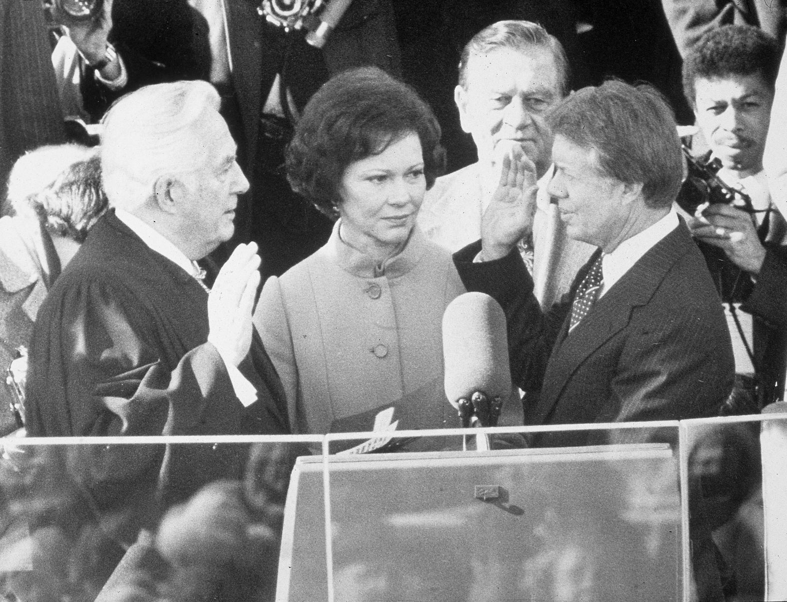 Chief Justice Warren Burger swears Carter into office on January 20, 1977, while Rosalynn Carter looks on.